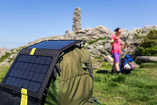 Rosie on the House solar charger on backpack