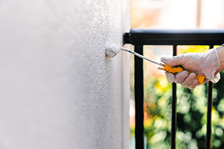 Rosie on the House Repairing and Repainting Stucco House