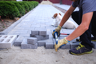 Rosie on the House Laying Pavers